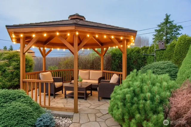a backyard of a house with table and chairs