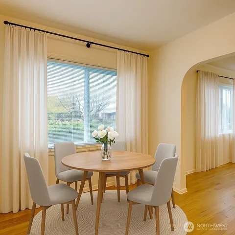 a view of a dining room with furniture and wooden floor