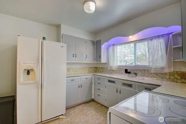 a kitchen with a sink stove and refrigerator