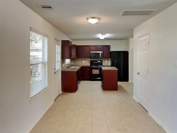 a kitchen with stainless steel appliances granite countertop a refrigerator and a sink