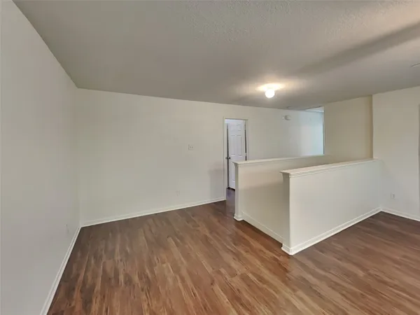 an empty room with wooden floor