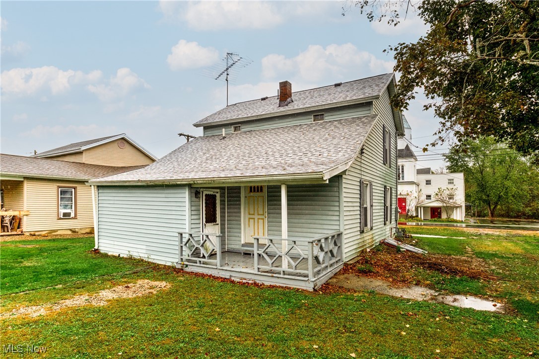 7529 State Line Burghill, OH 44404 - Photo 20 of 23 Rear view of house with roof with shingles, a yard, and a chimney