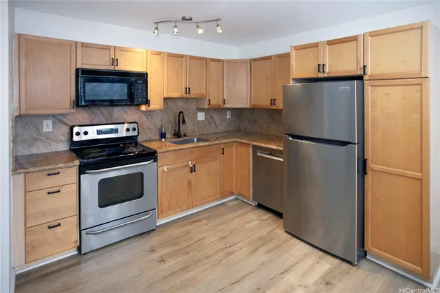 a kitchen with a refrigerator sink and microwave