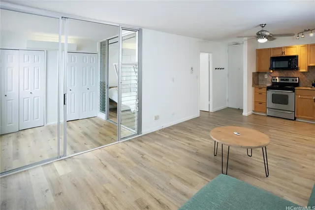 a view of a kitchen with furniture and wooden floor