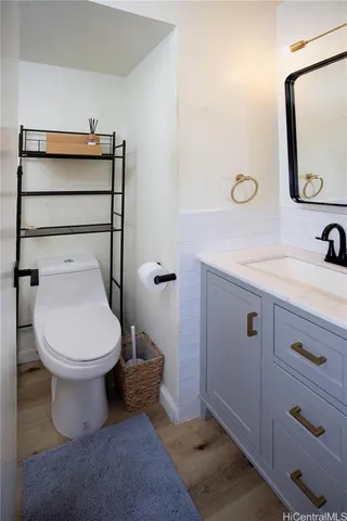 a bathroom with a toilet sink and mirror