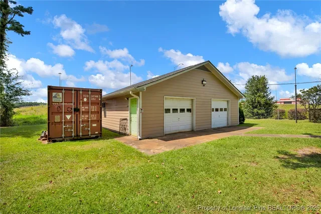 a view of a house with a yard and garage