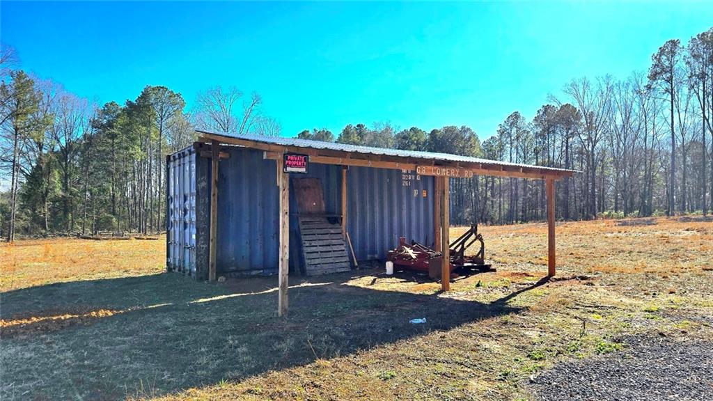 68 Lowery Rd S West Kingston, GA 30145 - Photo 5 of 14 a view of a backyard with a tree