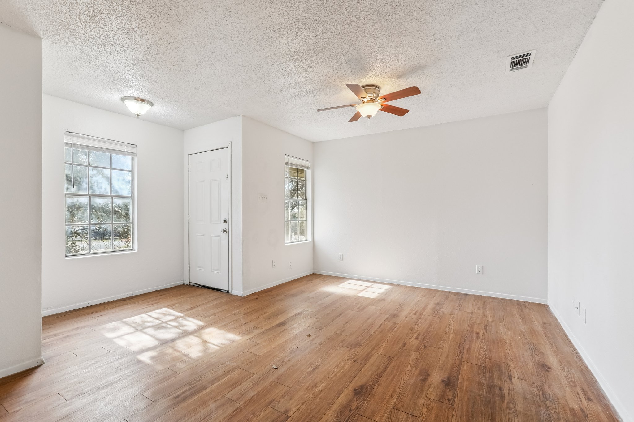 5000 Weidemar Lane, Unit C Austin, TX 78745 - Photo 1 of 8 wooden floor in an empty room with a window