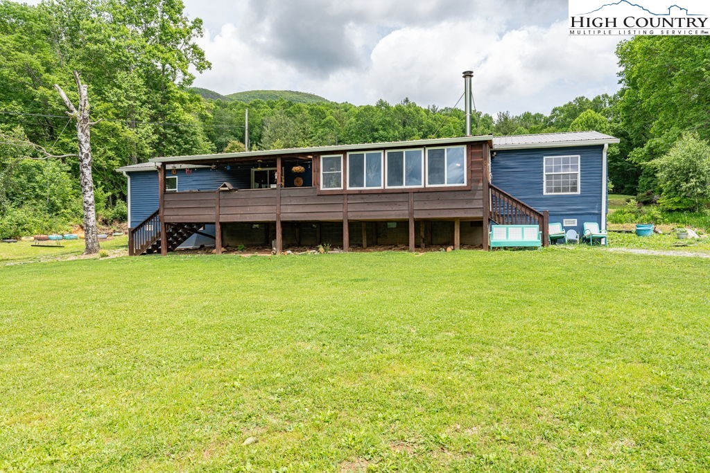 285 Roaring Fork Road Todd, NC 28684 - Photo 2 of 41 a view of a house with yard and sitting area