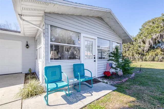 a backyard of a house with outdoor seating