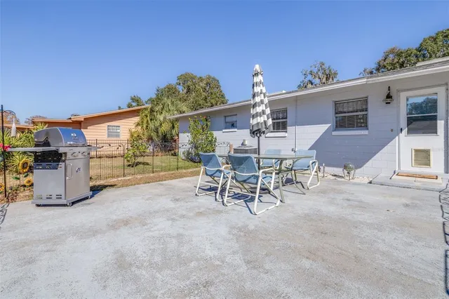a view of a patio with a table and chairs and potted plants