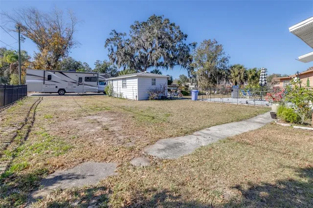a front view of a house with a yard and tree s