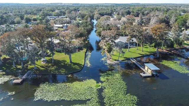 an aerial view of a house with a yard basket ball court and outdoor seating