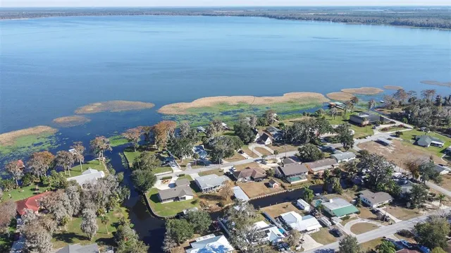 an aerial view of a house with a lake view