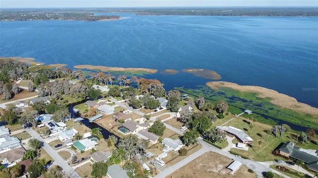 an aerial view of a house with a lake view