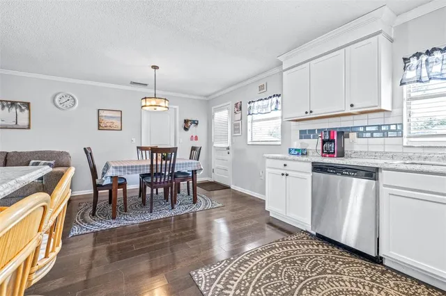 a view of dining table chairs and window