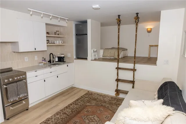 a kitchen with a stove a sink and cabinets