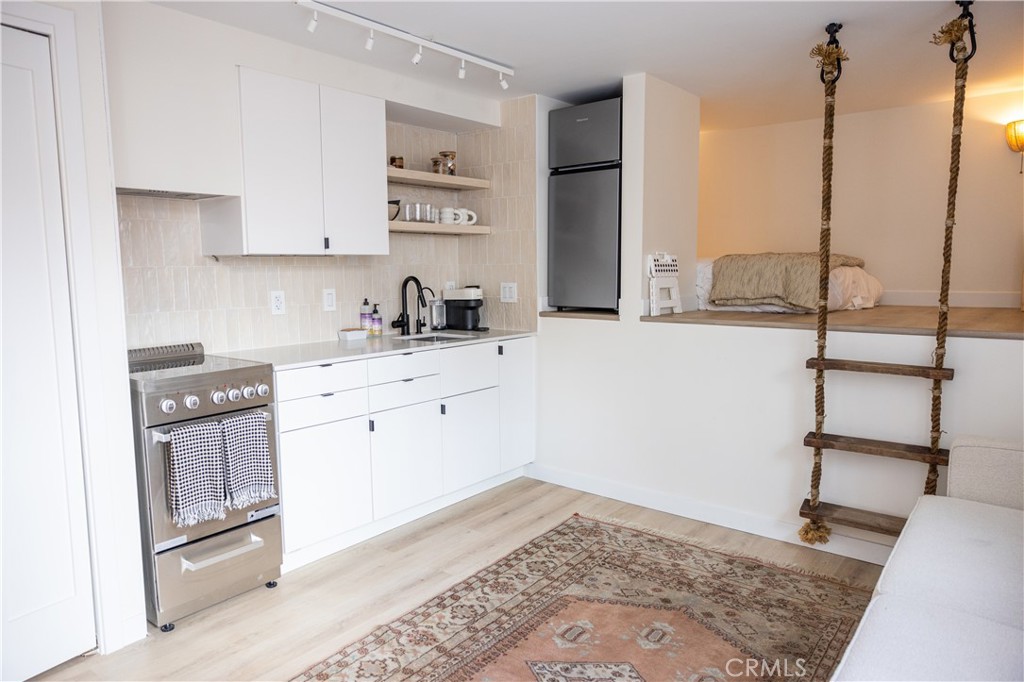 160 Avenida Florencia, Unit C San Clemente, CA 92672 - Photo 2 of 10 a kitchen with a sink appliances and cabinets
