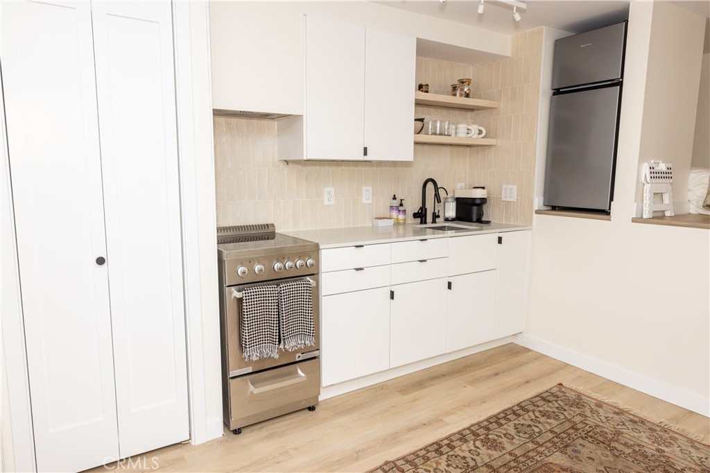 160 Avenida Florencia, Unit C San Clemente, CA 92672 - Photo 3 of 10 a kitchen with a sink cabinets and appliances
