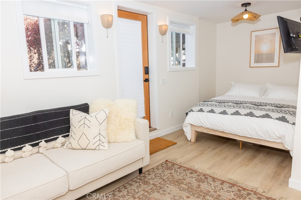 160 Avenida Florencia, Unit C San Clemente, CA 92672 - Photo 4 of 10 a bedroom with a bed and wooden floor