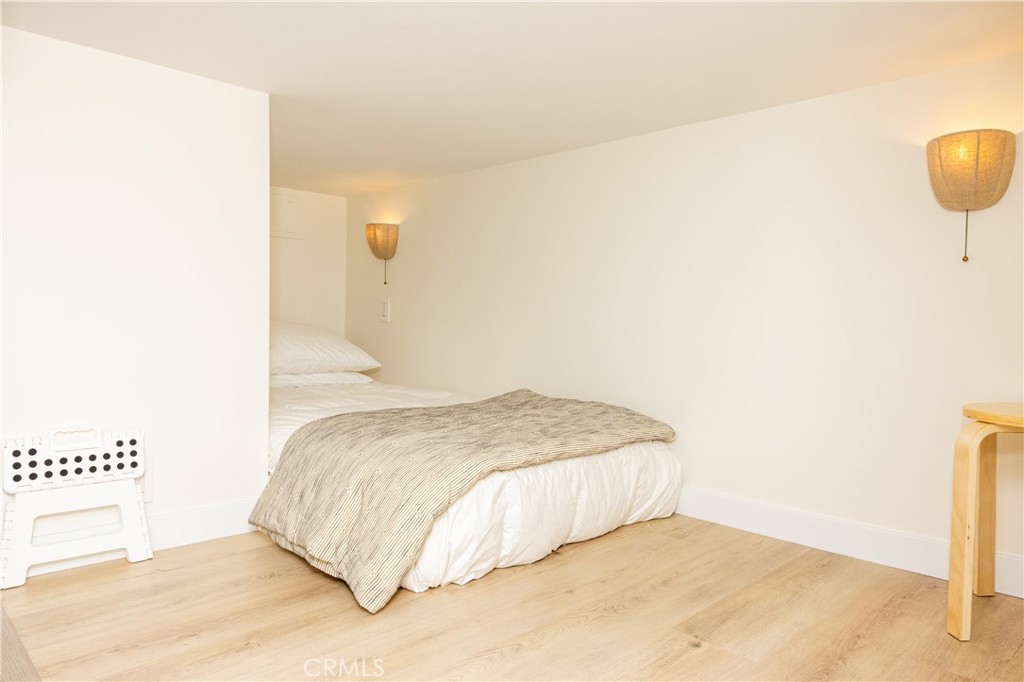 160 Avenida Florencia, Unit C San Clemente, CA 92672 - Photo 7 of 10 a bedroom with a bed and a night stand