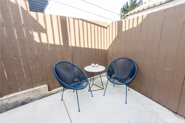 a backyard of a house with table and chairs