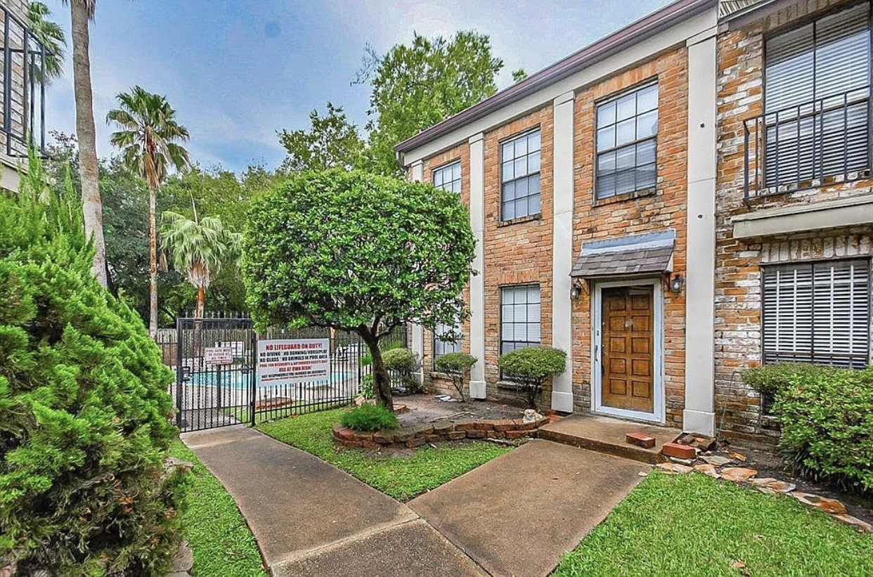 a front view of a house with yard and green space