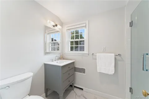 a bathroom with a sink toilet and mirror