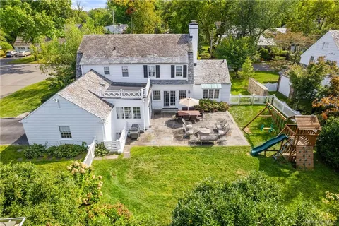 an aerial view of a house with swimming pool garden and patio