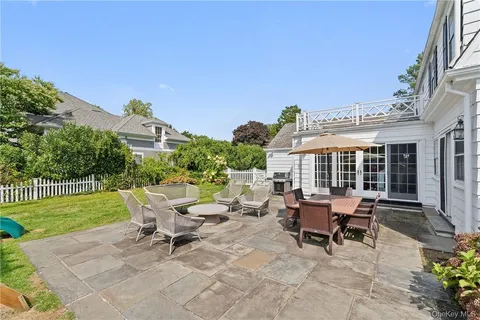 a view of a house with backyard sitting area and garden