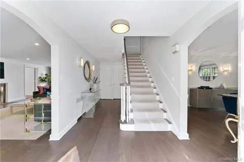 a view of entryway and hall with wooden floor