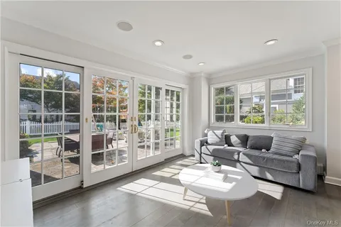 a living room with furniture and floor to ceiling windows