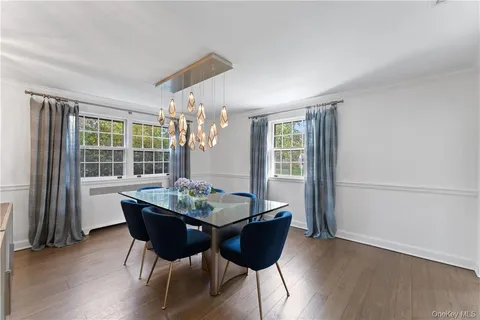 a dining room with furniture and wooden floor