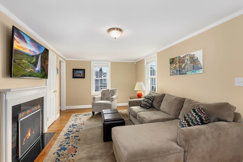 381 Appleton Street Arlington, MA 02476 - Photo 4 of 39 a living room with furniture a fireplace and a flat screen tv