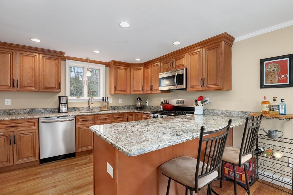 381 Appleton Street Arlington, MA 02476 - Photo 8 of 39 a kitchen with granite countertop a stove a sink a dining table and chairs