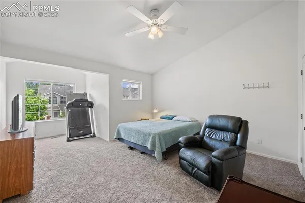 a room with furniture and a ceiling fan