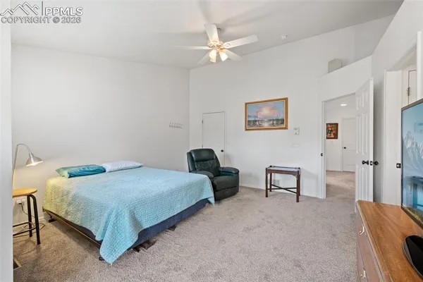 a bedroom with a bed and a desk