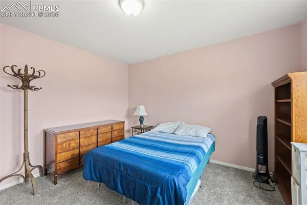 a bedroom with a bed and a mirror