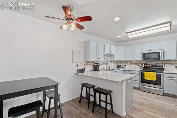 a view of kitchen with cabinets table and chairs