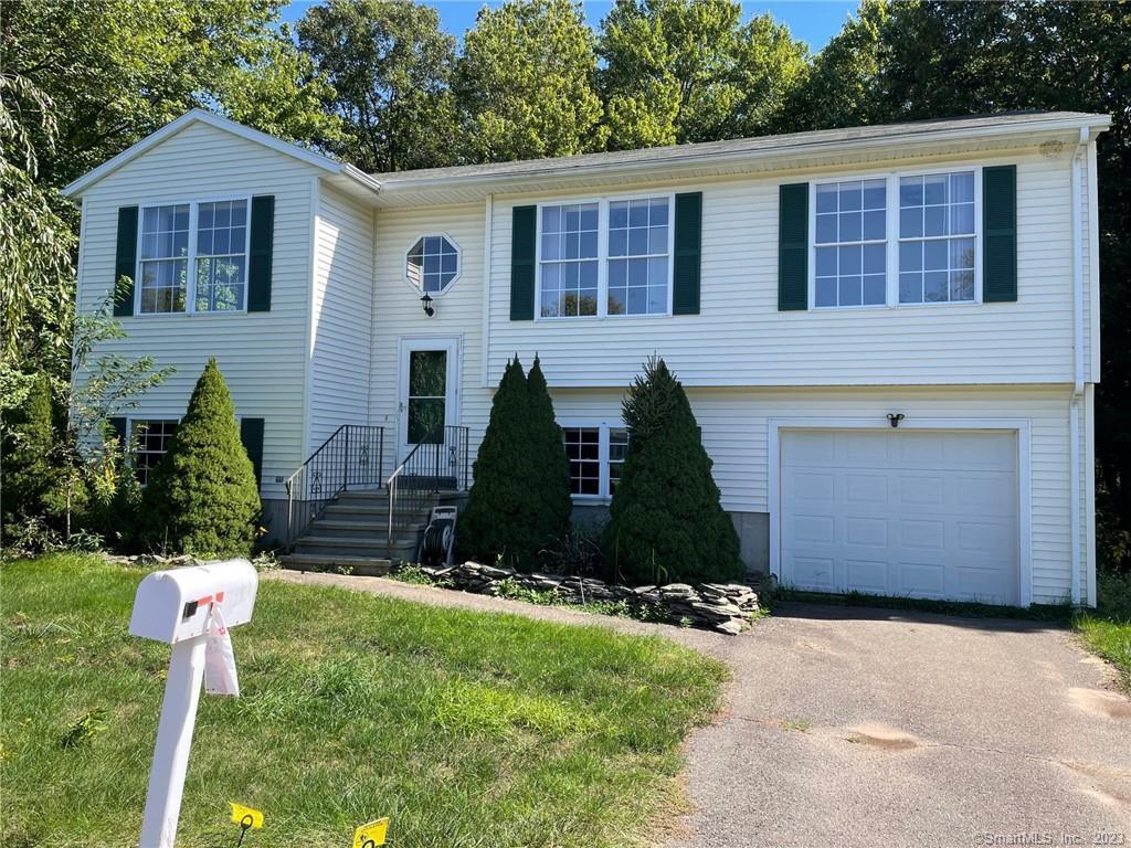 31 Samantha Lane Madison, CT 06443 - Photo 1 of 1 a front view of a house with a yard and garage