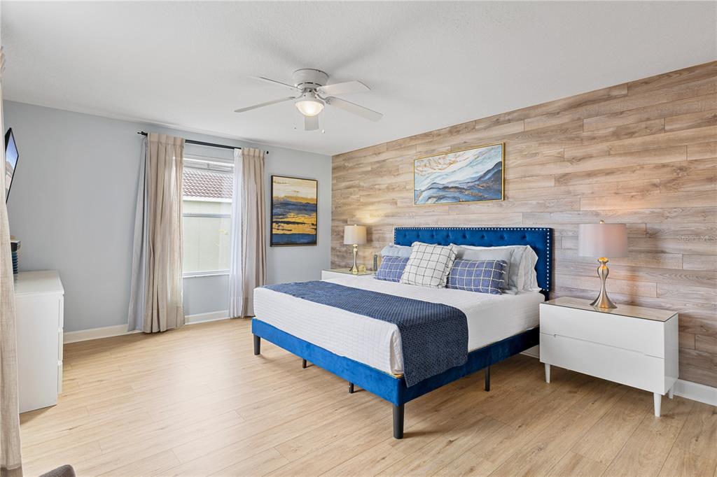 9006 Majesty Palm Road Kissimmee, FL 34747 - Photo 37 of 56 a spacious bedroom with a bed and a couch