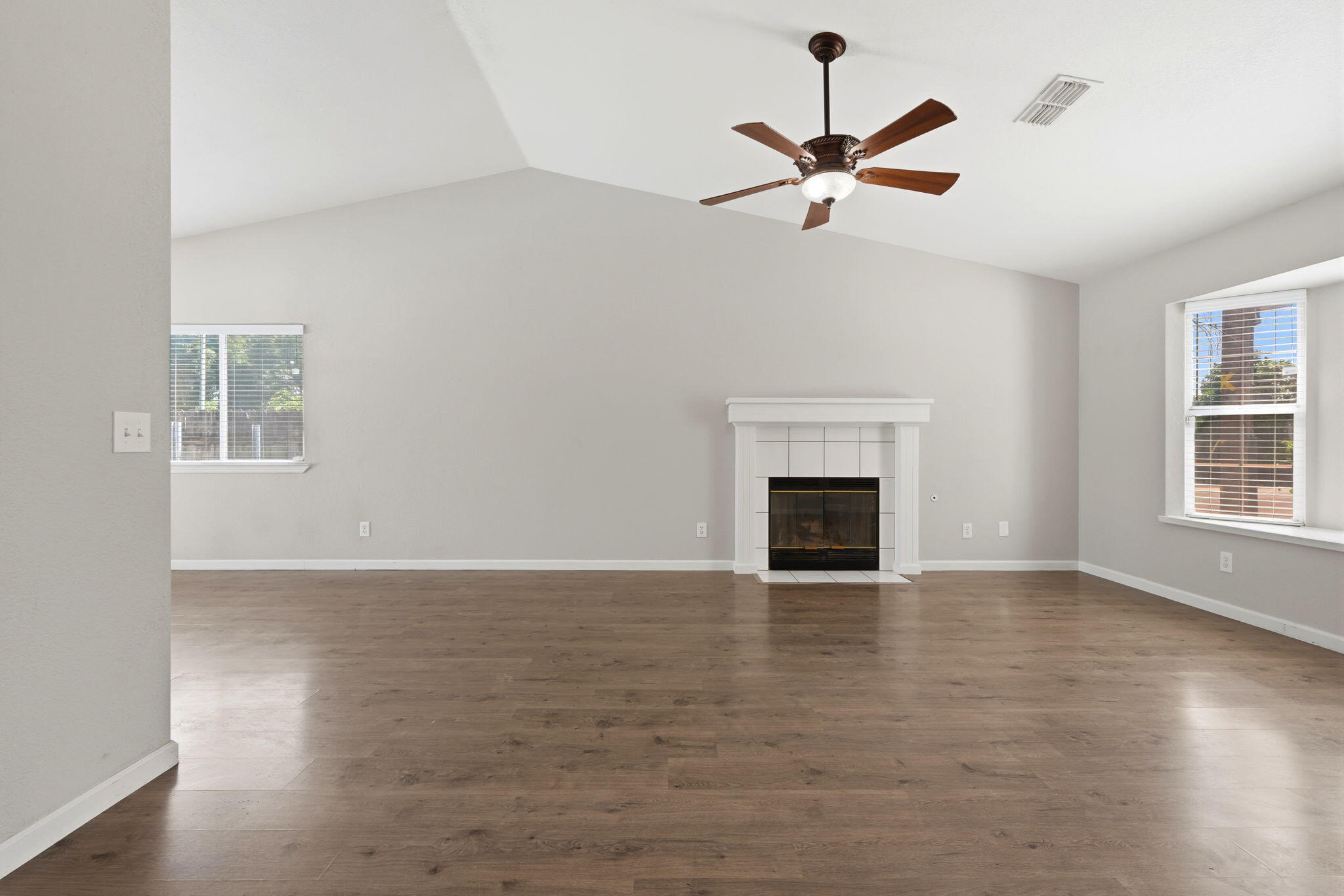 481 Katelyn Court Exeter, CA 93221 - Photo 7 of 33 a view of an empty room with wooden floor and a window
