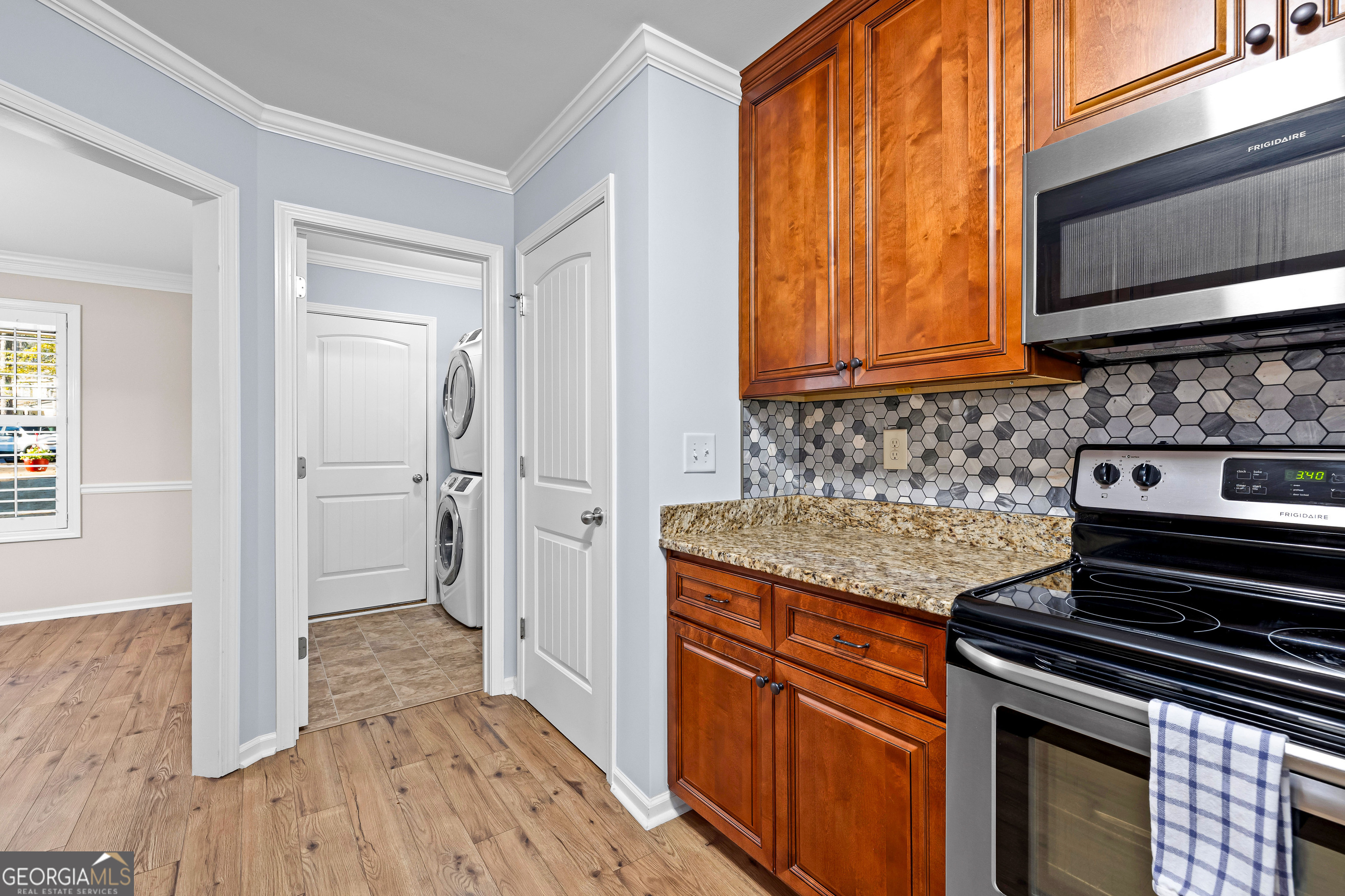 4 Buttonbush Court Newnan, GA 30265 - Photo 16 of 40 a kitchen with granite countertop wooden cabinets and a stove top oven