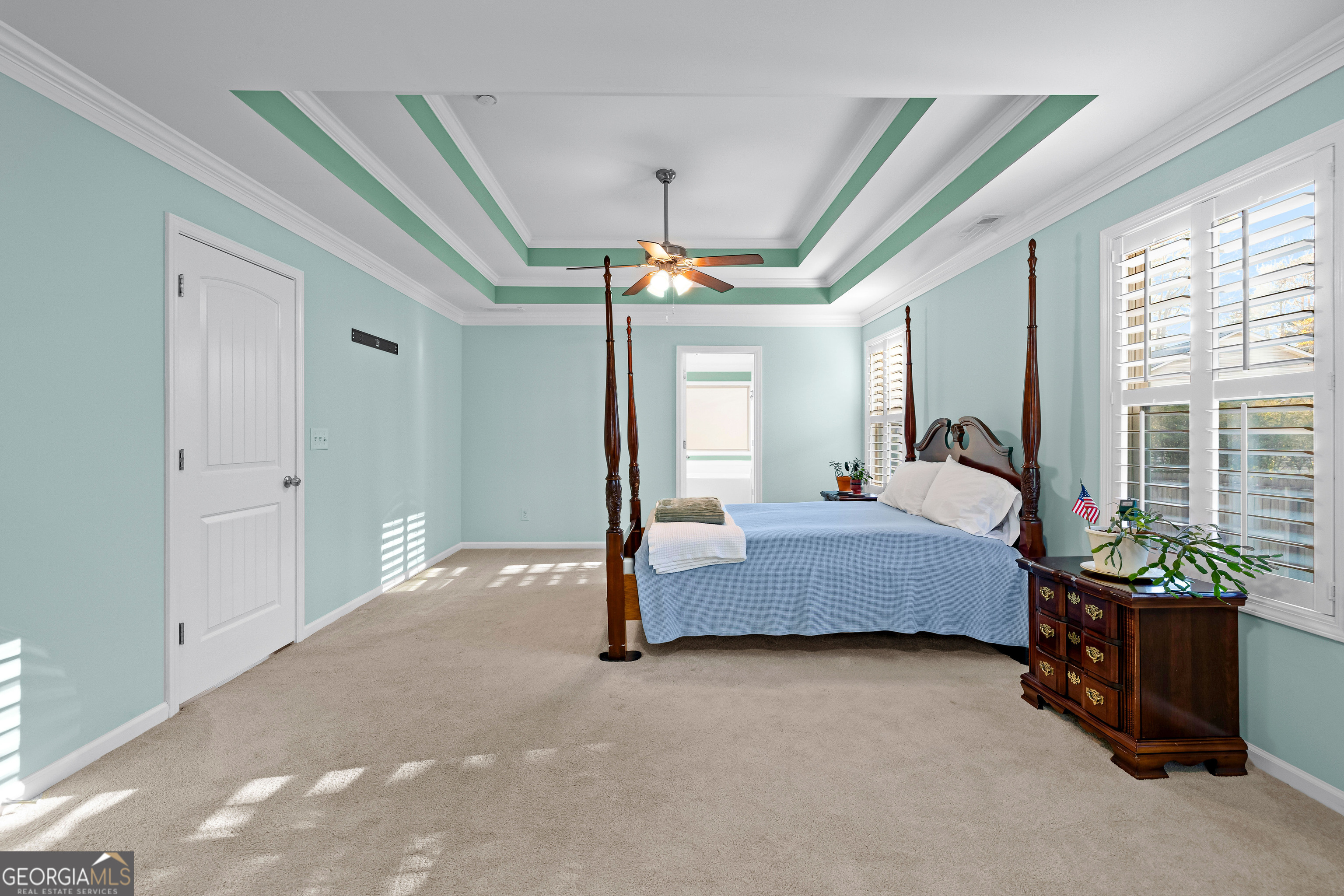 4 Buttonbush Court Newnan, GA 30265 - Photo 22 of 40 a spacious bedroom with a bed and a chandelier