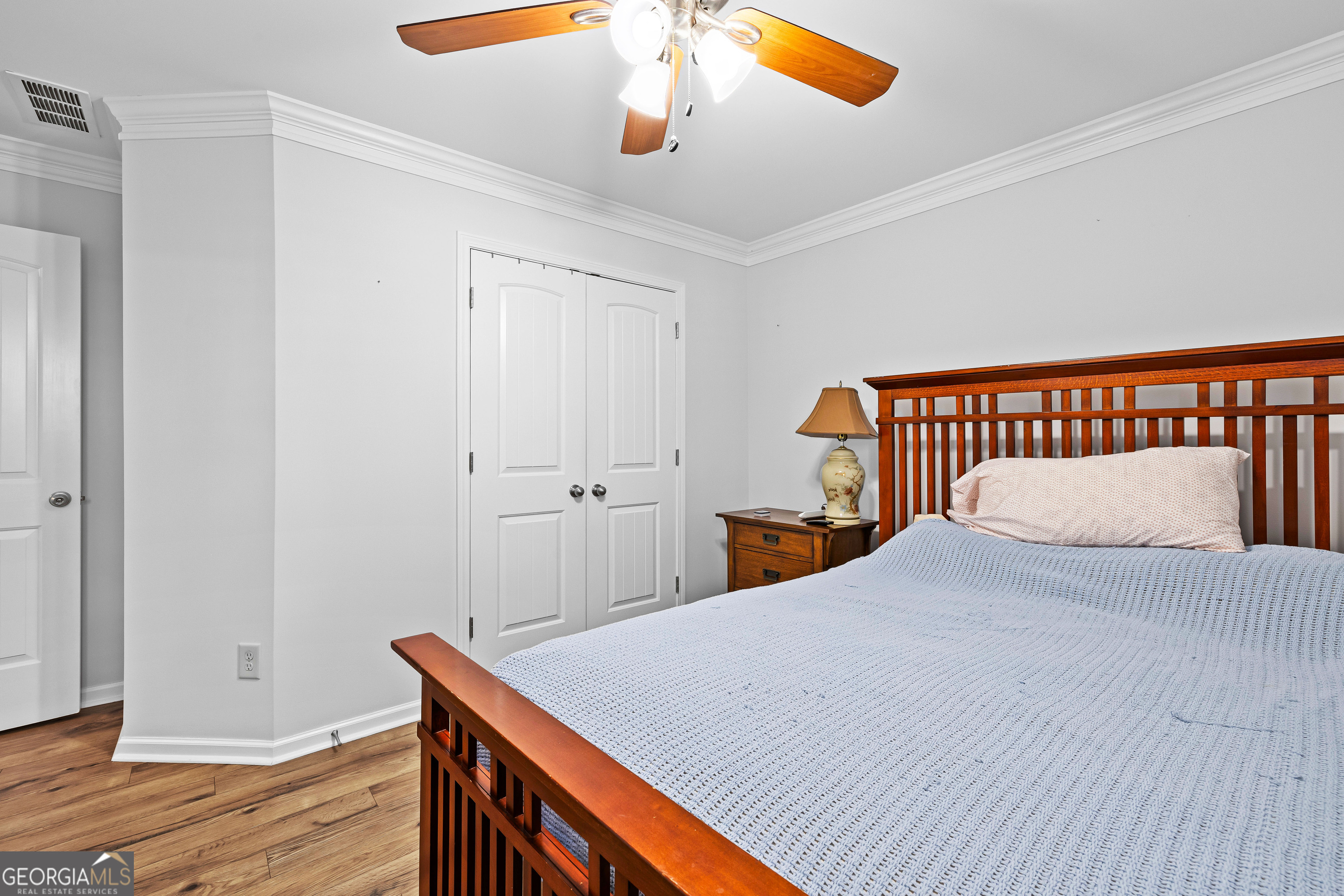 4 Buttonbush Court Newnan, GA 30265 - Photo 34 of 40 a bedroom with a bed and a chandelier