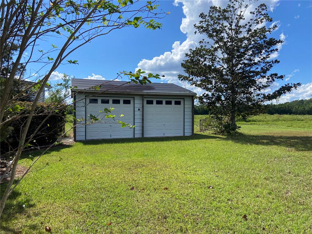 5559 Southwest 42nd Place Bell, FL 32619 - Photo 11 of 48 a front view of a house with a garden