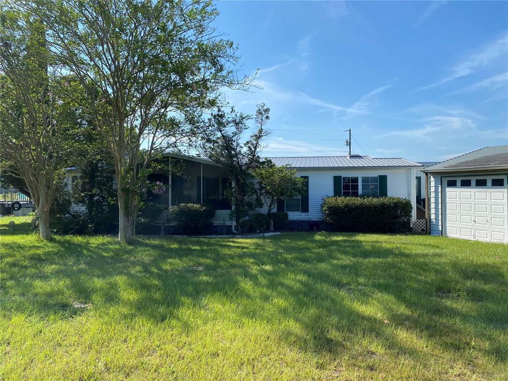 5559 Southwest 42nd Place Bell, FL 32619 - Photo 13 of 48 a house view with a sitting space and garden