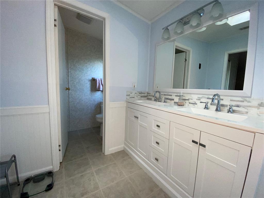 5559 Southwest 42nd Place Bell, FL 32619 - Photo 26 of 48 a spacious bathroom with a sink and a mirror