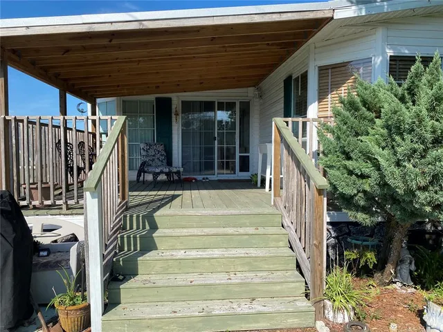 a house view with a sitting space and garden