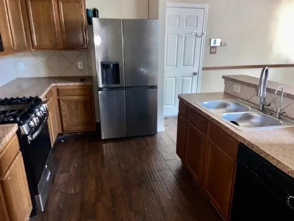 a kitchen with a sink stove and refrigerator